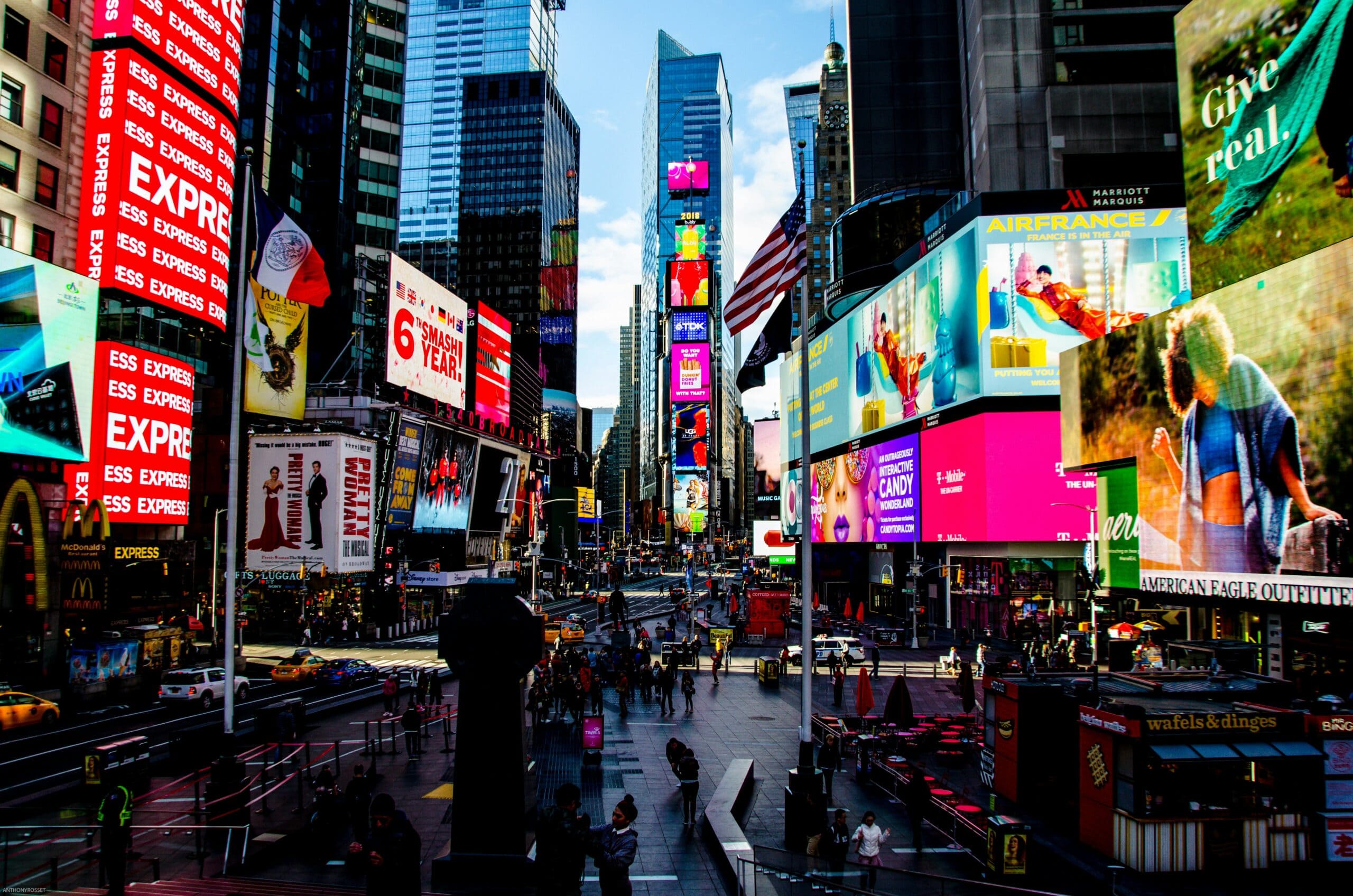 Colorful billboards and busy street scene in Times Square, New York City.